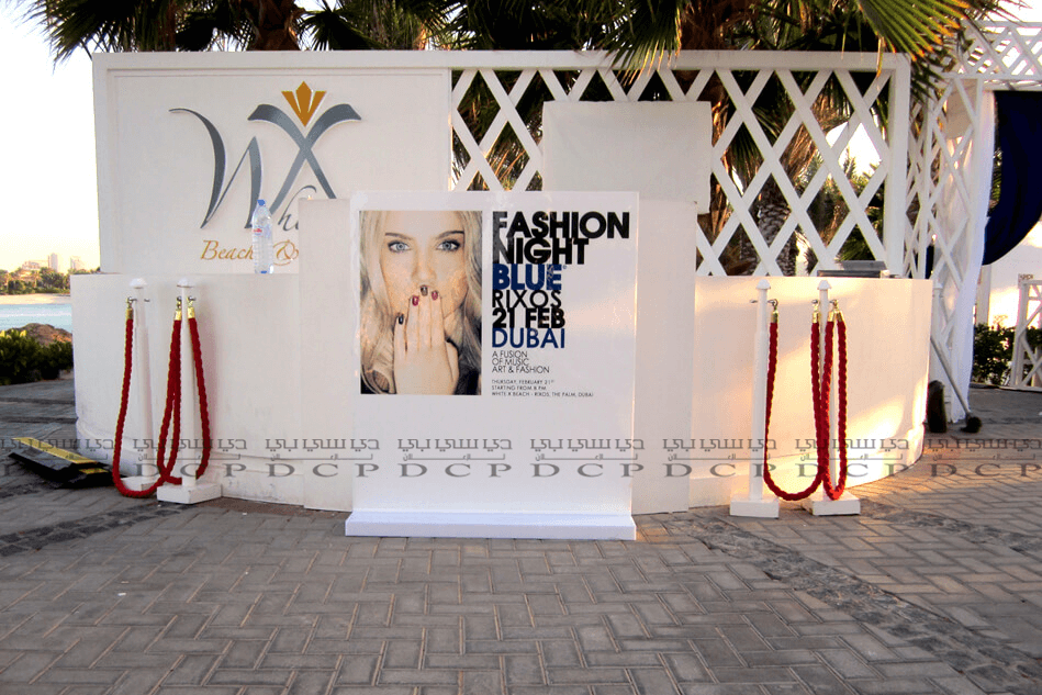 Custom exhibition stand with vibrant graphics, integrated lighting, and modular shelving for a professional trade show display